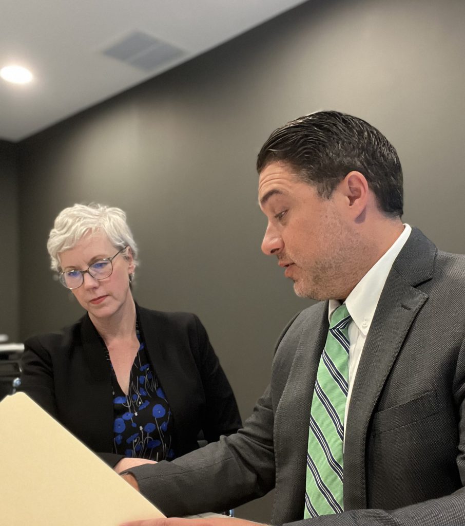 Riehl Law attorneys reviewing a case file together